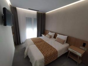 Postel nebo postele na pokoji v ubytování Minoa Hotel