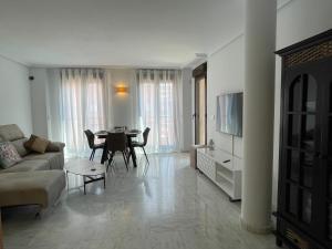 a living room with a couch and a table at Bonito Apartamento en el Centro de Moraira in Moraira