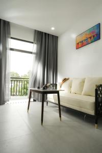 a living room with a couch and a table at DAD Resort Phú Quốc in Phú Quốc