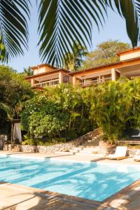 a resort with a swimming pool and a building at PortoBay Búzios in Búzios