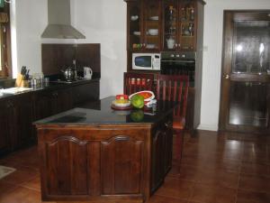 a kitchen with a island in the middle of a room at Palm Beach Villa in Wadduwa