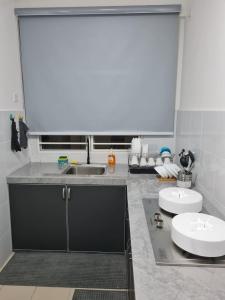 eine Küche mit einer Spüle und einer Arbeitsplatte in der Unterkunft Teratak impian PPAM Saderi Putrajaya in Putrajaya