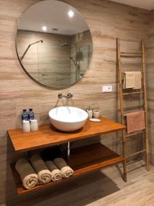 a bathroom with a sink and a mirror at Maravilloso Guesthouse in Fuengirola