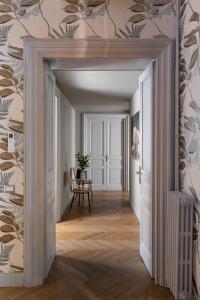 an open hallway with a dining room with wallpaper at Glance in Rome in Rome +69 photos
