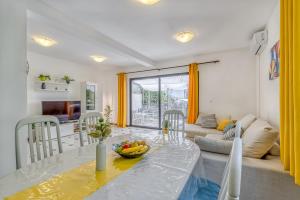 a living room with a table and a couch at Wellness Apartment in Poreč