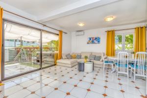 a living room with a couch and a table at Wellness Apartment in Poreč