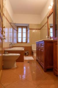 a bathroom with a tub and a toilet and a sink at Villa Sikioti in Ierissos