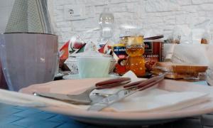 a plate with a fork and knife on a table at La Tana del Nano in Ancona