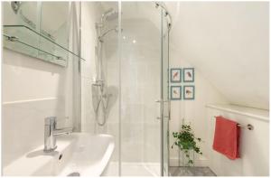 a white bathroom with a shower and a sink at Wells City Centre, Quiet Mews House, sleeps 6 in Wells +26 photos