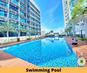 a swimming pool in front of a building at Pacific Tower Petaling Jaya By Shamrock in Petaling Jaya