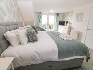 a bedroom with a large bed with white pillows at Craybourne in Falmouth