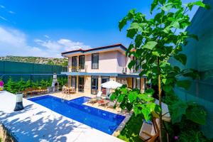 a villa with a swimming pool and a house at Villa Destan Patara in Gelemiş