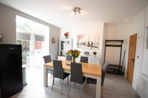 a dining room with a table and chairs at Ideal Lodgings in Bury in Bury