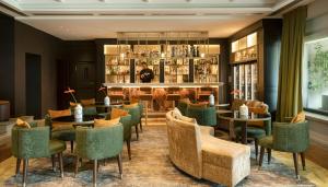 a restaurant with tables and chairs and a bar at Castelfalfi in Castelfalfi