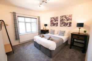 a bedroom with a bed and a window at Ideal Lodgings in Bury in Bury