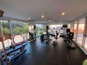 a gym with several treadmills and machines in a room at Sands Condo Studio 14 by ThaiminatorPattaya in Pattaya South