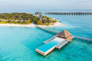 an island in the ocean with a pier and a resort at Heritance Aarah-Premium All Inclusive in Raa Atoll