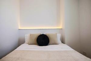 a pillow sitting on top of a bed in a room at Phaedrus Living - Seaside Executive Flat Harbour 203 in Paphos