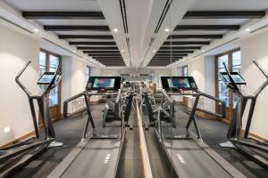 a gym with several treadmills in a room at Palacio Solecio, a Small Luxury Hotel of the World in Málaga