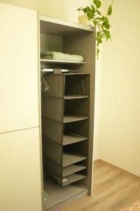 a cupboard with shelves in it next to a refrigerator at Gästewohnung Merci in Merseburg