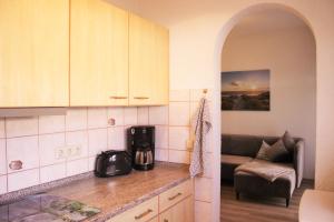 a kitchen with a counter and a couch in a room at Gästewohnung Merci in Merseburg