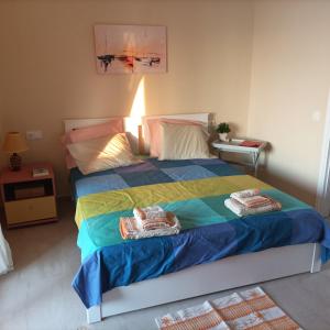 a bedroom with a bed with towels on it at Beatrice's apartment in Acharavi