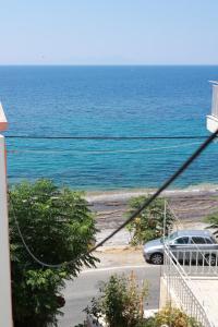 a view of the ocean from a house at Beautiful apartment in Plomari in Plomarion