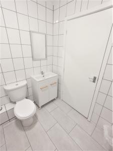 a white bathroom with a toilet and a sink at Yarm Lane Apartments - Stockton Town Centre in Stockton-on-Tees