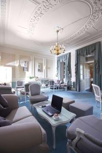 a room with couches and a laptop on a table at Best Western Moores Central Hotel in St. Peter Port