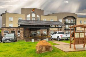 a large building with cars parked in front of it at Comfort Inn & Suites in Medicine Hat