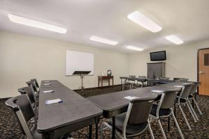 a classroom with tables and chairs and a whiteboard at Baymont by Wyndham Fremont in Fremont