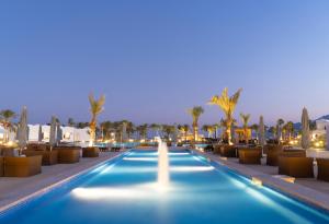 a swimming pool with a fountain in the middle of a resort at Safir Dahab Resort in Dahab