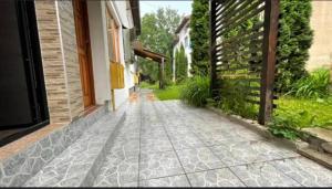 a walkway outside of a house with a fence at Apartman Uma in Sarajevo