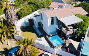an aerial view of a house with a swimming pool at BEACH HOUSE MOSSELRIVIER in Langebaan