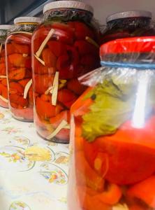 a group of jars of pickled vegetables on a table at VILLA GHERMAN in Sălciua de Jos