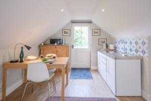 a kitchen with a table and a sink and a table at Poplar Farm Cartlodge Earl Soham Air Manage Suffolk in Woodbridge