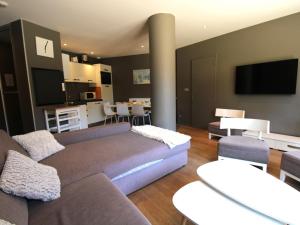 a living room with a couch and a dining room at Appartement Avoriaz, 4 pièces, 8 personnes - FR-1-633-13 in Avoriaz