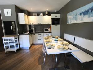 a kitchen with a white table with plates on it at Appartement Avoriaz, 4 pièces, 8 personnes - FR-1-633-13 in Avoriaz