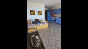 a room with a bed and a phone in it at Appartamento - Villaggio Terrata- Golfo Aranci in Marinella