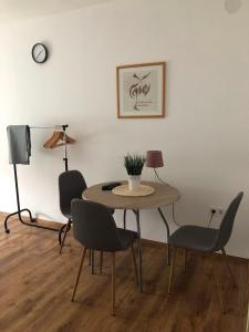 a dining room with a table and chairs at Borbély apartman in Nagykanizsa