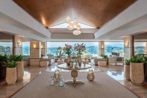 a large lobby with a table with glasses and flowers at Iberostar Selection Jardín del Sol Suites - Adults Only in Santa Ponsa