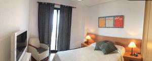 A bed or beds in a room at Playa Paraiso 27A