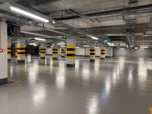 an empty parking garage with yellow and black poles in it at ibis Styles Kraków Centrum in Krakow +37 photos
