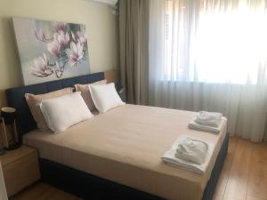 a bedroom with a bed with two towels on it at RELAX Apartments in HASKOVO, Apt2 in Haskovo