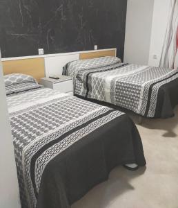 Cama o camas de una habitación en Hostal la Campana