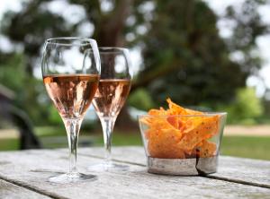 two glasses of wine and chips on a table at Luxury Escape in Hunstanton