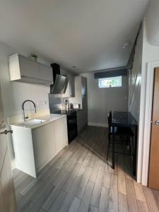 a kitchen with a sink and a table in it at The Annexe, Farnborough in Farnborough