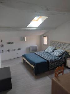 1 dormitorio con 1 cama con edredón azul en l arbre à chats, en Saint-Martin-de-Brômes
