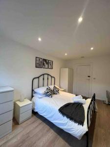 a bedroom with a large bed and a dresser at Fully equipped 2 bed flat on Old Compton St! in London