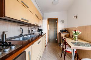 a kitchen with a sink and a table at Sunsets at the Palace in Bucharest